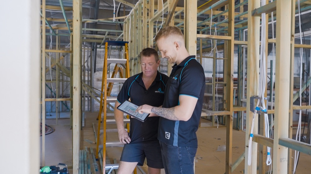 Our crew checking the plans on a framed home