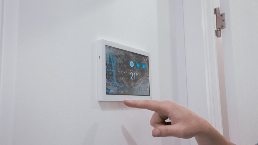 Wall mounted air conditioning zone controller showing 21 degrees