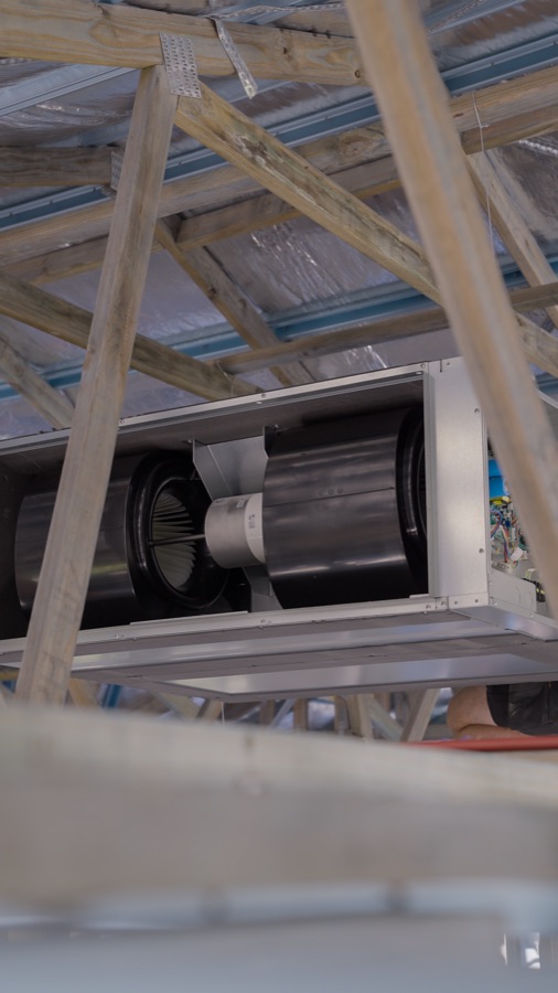 A ducted indoor unit installed in the roof framing