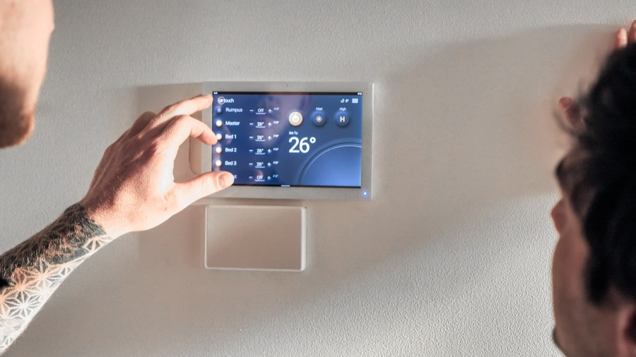 Hand adjusting an AirTouch 5 zone controller on a ducted system