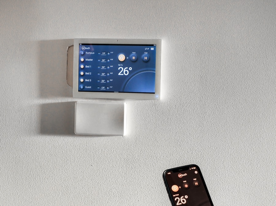 AirTouch 5 zone controller on a wall with the phone app