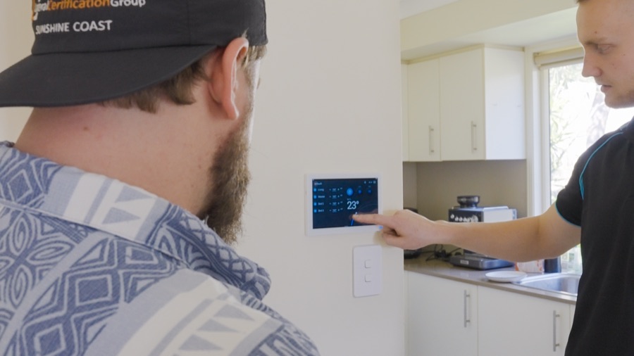 Technician showing a client the AirTouch 5 zone controller