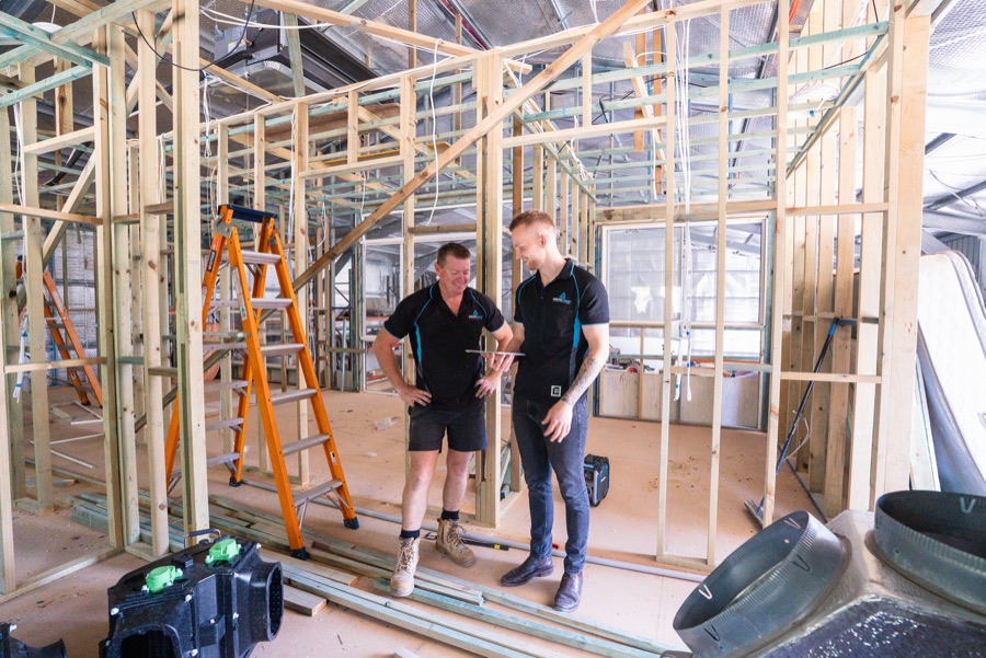 Delta Temp technicians planning ducted work in a new build frame