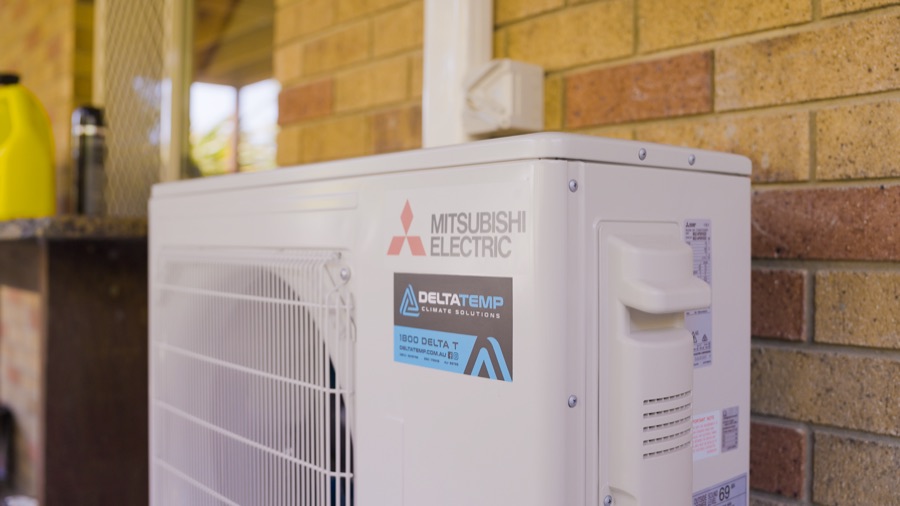 Mitsubishi Electric split system outdoor unit on a brick wall