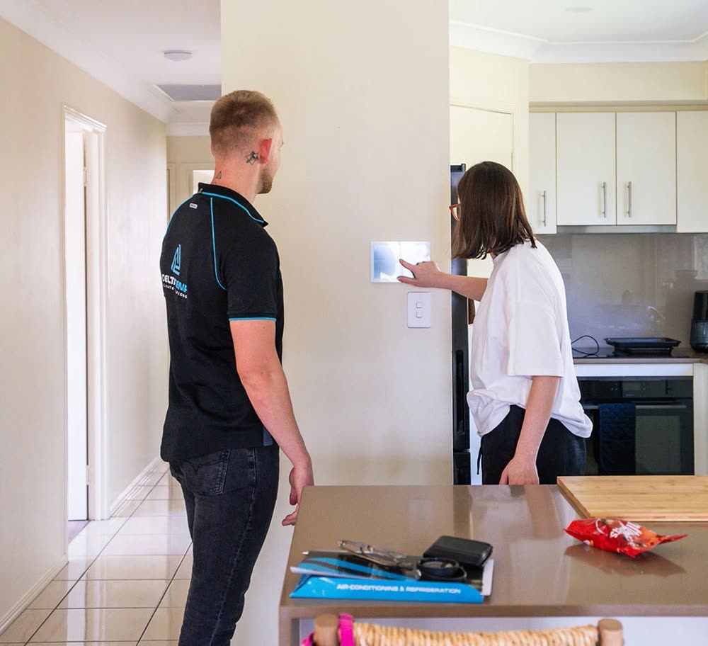 A Delta Temp consultant talking a homeowner through their wall controller