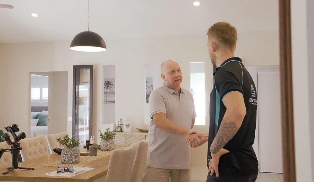 A Delta Temp installer with a homeowner after handover