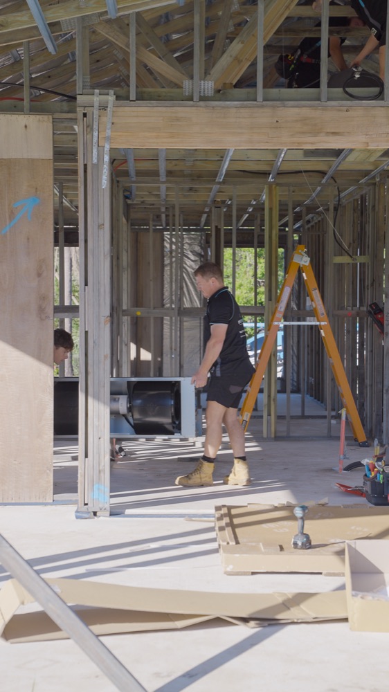 A Delta Temp installer on a framed new home